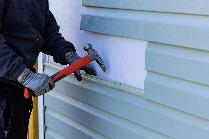 reconstructing-exterior-house-damaged-plastic-siding-replaced